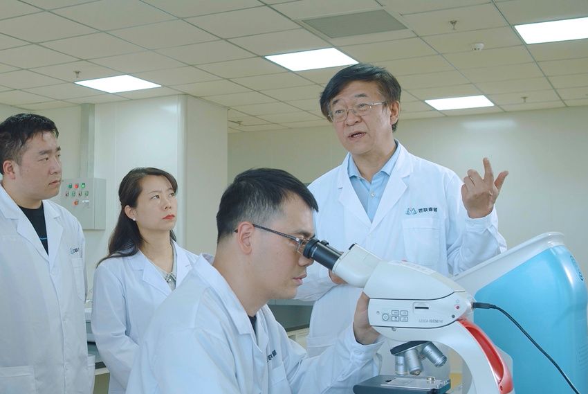 田卫东教授（右一）与研发团队在实验室研讨。受访者供图